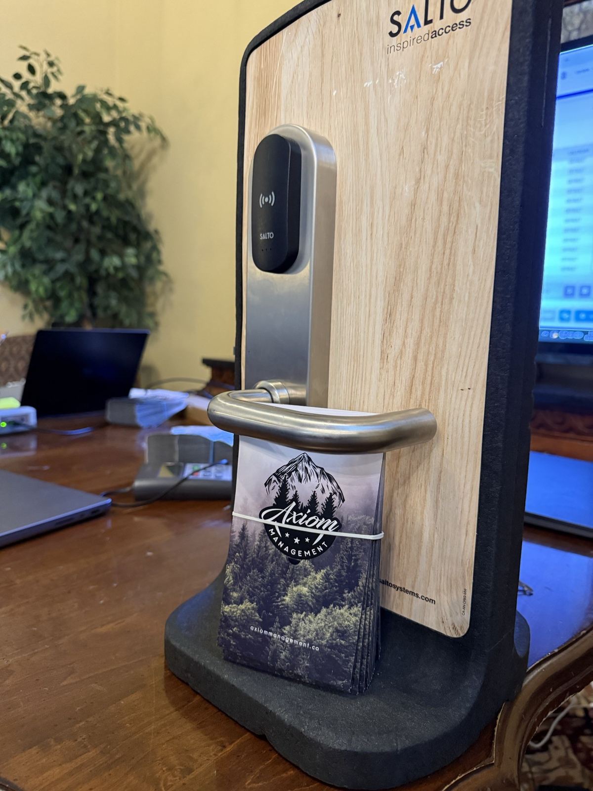 A SALTO door lock with an Axiom-branded key card