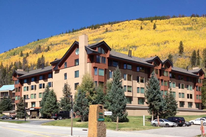 Telemark Lodge with fall aspens on the hillside behind it